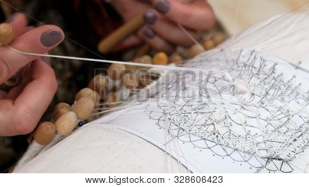 Close-up Of Female Hands Fingering Coils Between Fingers. Hand Weaving Lace Craft. The Craftswoman S
