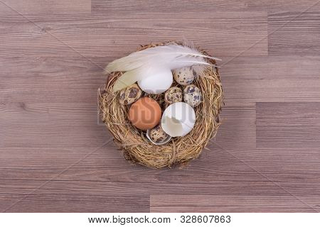 Deco Easter Nest Basket With Eggs Feathers On Wooden Background. Beautiful Decoration Easternest Wit
