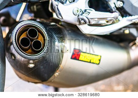 A Close-up Photo Of Akrapovic Exhaust Muffler On Custom Motorcycle In Bucharest, Romania, 2019