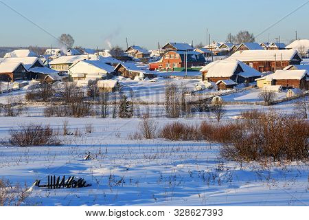 Panoramic View Of The Russian Village On A Sunny Winter Day. View Of The Traditional Country Houses.