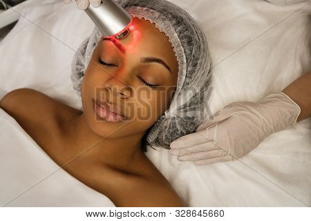 Ultrasound Chromotherapy. Hardware Cosmetology. Beautician Carries Out Procedure For Face Skin Rejuv