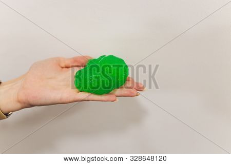 Slime, Green Pate Elastic And Vicous On Childs Hand.
