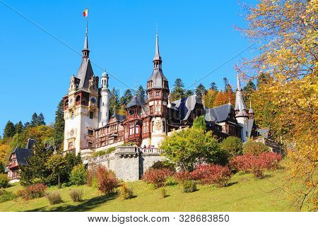 Peles Castle, Romania. Beautiful Famous Royal Castle And Ornamental Garden In Sinaia Landmark Of Car