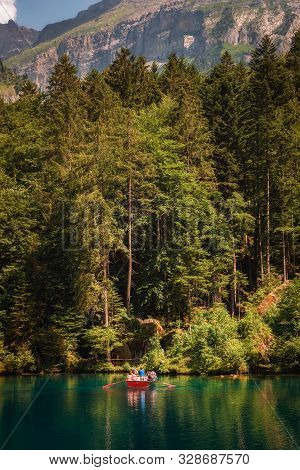 Blausee Lake, Switzerland - July 23, 2019 : Tourists Taking A Boat Trip On Blausee Lake Located In T