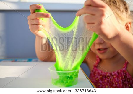 Hand Holding Homemade Toy Called Slime, Kids Having Fun And Being Creative By Science Experiment. Cl