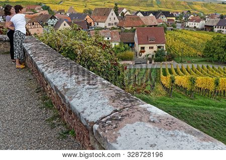 Hunawihr, France, October 13, 2019 : Women Admire The Vineyard Landscape Around The Village From The