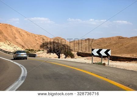 Car On A Highway That Runs Along The Dead Sea From One Side And Edom Mountains At Arava Desert From 