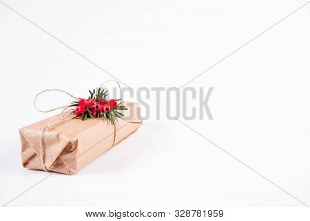 Gift Decorated With A Gunny String Bow And With A Common Yew Twig