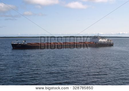 Solovetsky Islands, Russia - August 10, 2019: Cargo Ship Abramtsevo Is On The White Sea From The Isl