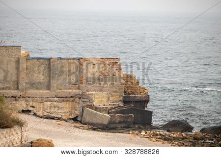 Ruined Stone Wall Enclosing Part Of The Beach For Private Construction