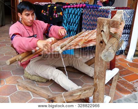 Cuenca, Ecuador - March 8, 2019: Ecuadorian Man Is Weaving Scarf Or Macana By Hand With Cotton Threa