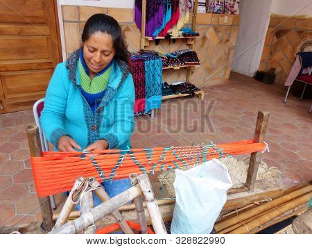 Cuenca, Ecuador - August 10, 2019: Ecuadorian Woman Prepares Cotton Threads For Painting And Weaving