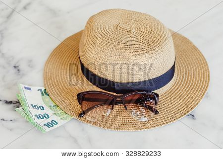 Sun Hat With Sunglasses And 100 Hundredth Euro Banknotes. Money Or Vacation Concept