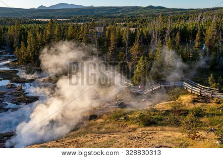 Sunset Over Artists Paintpot Trail As Steam Rises From The Geysers And Hot Springs At Yellowstone Na
