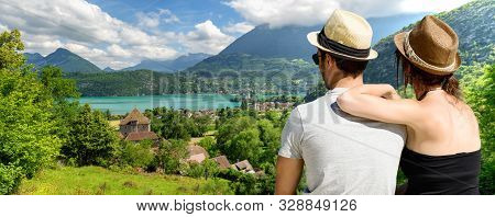 A Young Lovers Couple Watching Lake Of Annecy. France
