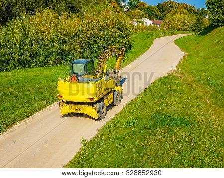 Construction Equipment In Nature. Escalator Rides On The Road.