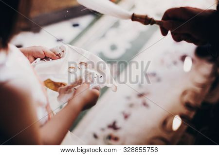 Wedding Rings On Plate For Wedding Matrimony In Church. Little Girl Holding Wedding Rings On Plate A