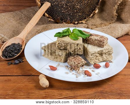 Various Crumbly Sunflower Halva With Peanuts, Vanilla And Cocoa Powder Addition, Decorated With Mint