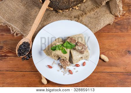 Various Crumbly Sunflower Halva With Different Addition, Decorated With Mint Twig. Peanuts, Sunflowe