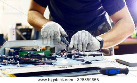 Professional Technician Detaches Monoblock Hard Drive Repairing It In Workshop.