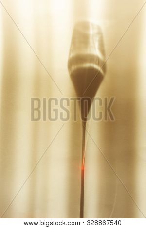 A Spectacular Long Shadow Falls From The Glass With Wine, Next To It Is The Shadow Of A Bottle Of Wi