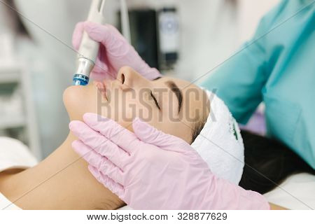 Close-up Of Woman Getting Facial Hydro Microdermabrasion Peeling Treatment. Female At Cosmetic Beaut