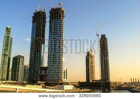 Dubai/uae - October 17, 2019: Under Construction Tall Buildings (skyscrapers) With Yellow Constructi