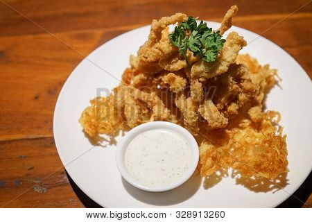 Fried Crispy Calamari Rings Breaded Squid Rings On A White Plate
