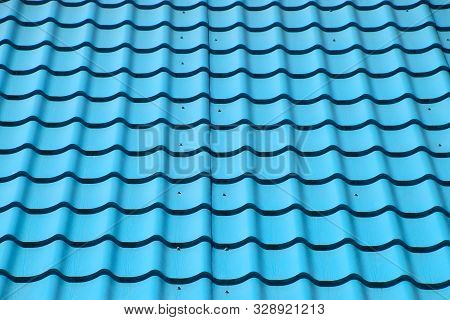 Turquoise Metal Tiles On The Roof Of The House. Modern Roofing Materials