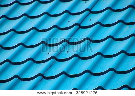 Turquoise Metal Tiles On The Roof Of The House. Modern Roofing Materials