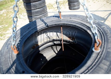 Homemade Punching Bag Made From Old Car Tires Fastened With Steel Reinforcement. Punching Bag