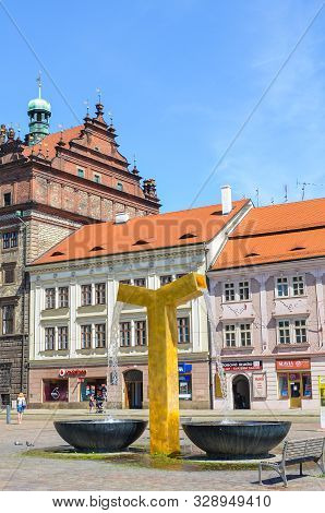 Pilsen, Czech Republic - June 25, 2019: The Main Square In Plzen, Czechia With Golden Water Fountain