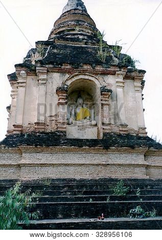 A Sculpture Of The Buddha Sits Inside A Chedi, Among The Ruins Of The Ancient Buddhist Temple Wat Ch