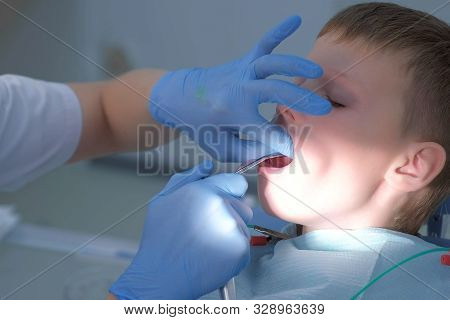 Dentist Rinses Boys Mouth Water Holding Saliva Ejector During Oral Hygienic Cleaning, Face Closeup, 