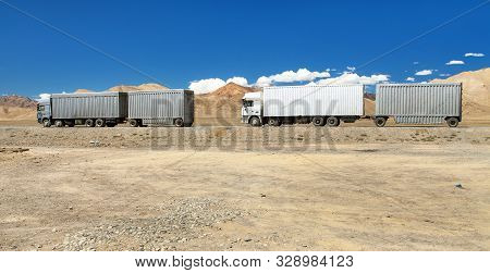 Pamir Highway Or Pamirskij Trakt And White Truck. Landscape Around Pamir Highway M41 International R