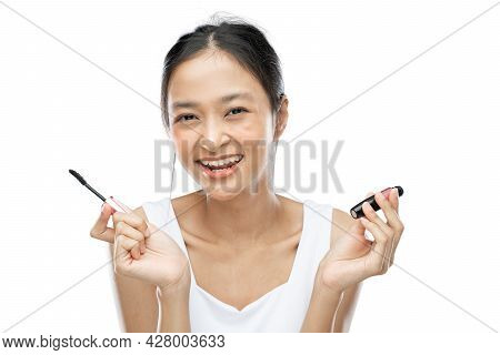 Smiling Asian Woman Wearing White Underdress Holding Mascara