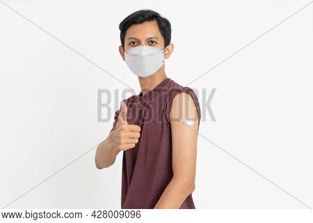 Asian Patient Getting Vaccinated Against Coronavirus By Doctor