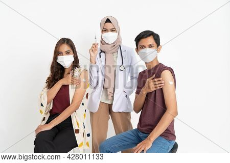 Asian Patient Getting Vaccinated Against Coronavirus By Doctor