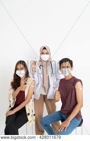 Asian Patient Getting Vaccinated Against Coronavirus By Doctor