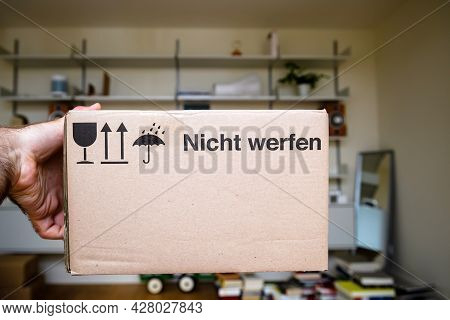 Pov Male Hand Holding Package Cardboard Box With Text In German Nicht Werfen Translated As Do Not Th