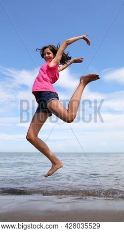 Caucasian Girls Jump Big Smiling And Happy By The Sea In Summer