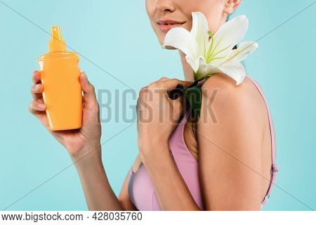 Cropped View Of Woman With Sunscreen And White Lily Isolated On Blue