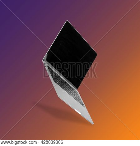 Laptop  Computer, Smart Phone And Smart Watch While Levitating In The Air On A Background Illuminate