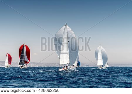 Sailboat Race With Multiple Yachts On A Sunny Day