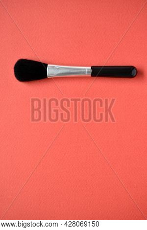Brush For Cleaning Optics On A Red Background