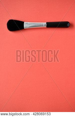 Brush For Cleaning Optics On A Red Background