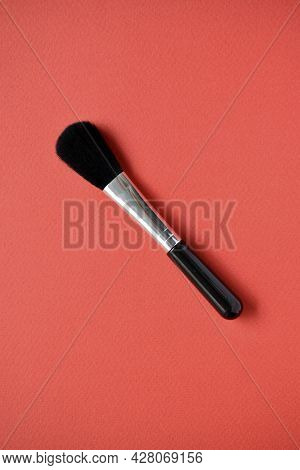 Brush For Cleaning Optics On A Red Background