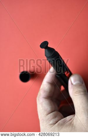 Brush For Cleaning Optics On A Red Background
