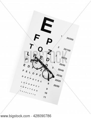 Eye Chart Test And Glasses On White Background, Top View. Ophthalmologist Tools