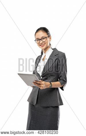 Young Pretty Business Woman Holding Tablet Wearing Suit Posing While Staring At The Camera